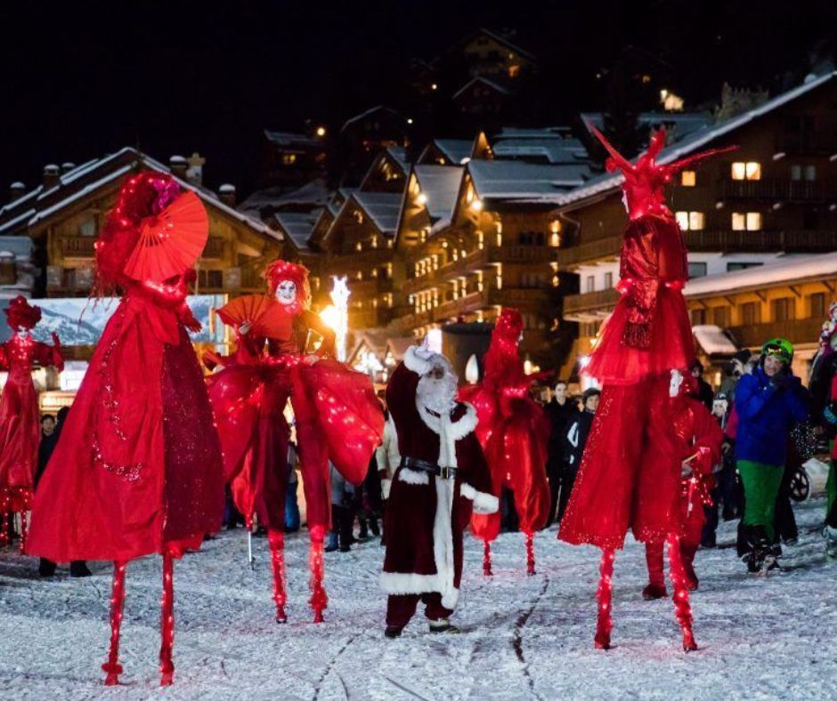 Christmas stilt walkers and Father Christmas on the Meribel snow front near Hotel Grangettes